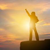 Person standing with their hand up in the air