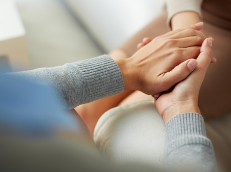two women holding hands