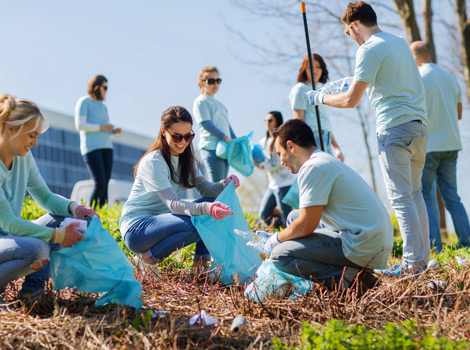 group of people doing volunteer work picking up trash
