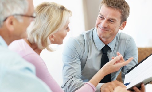 Financial representative having a discussion with a couple.