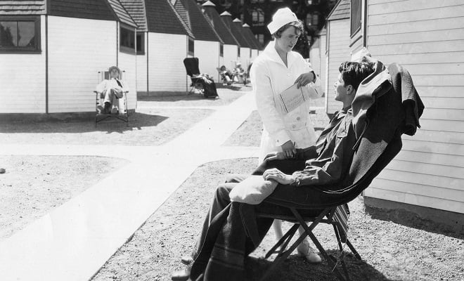 Image of a nurse caring for a tuberculosis patient.