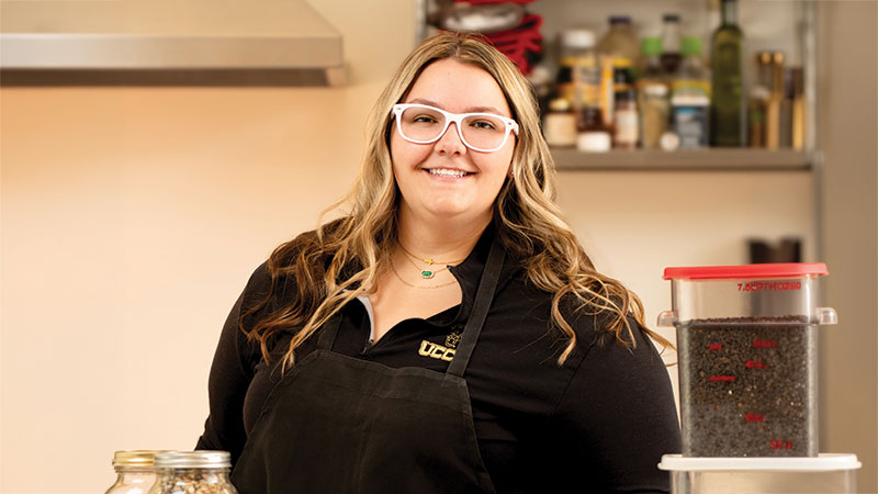 Modern Woodmen member Ashleigh posing at a kitchen counter.